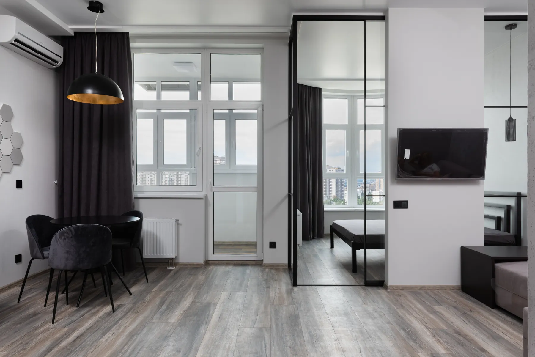 A light-filled living room with a wall-mounted heat pump
