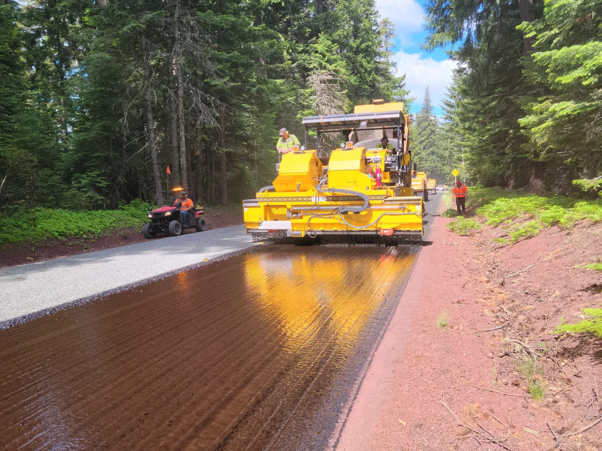 Asphalt paving machine laying a fresh road surface