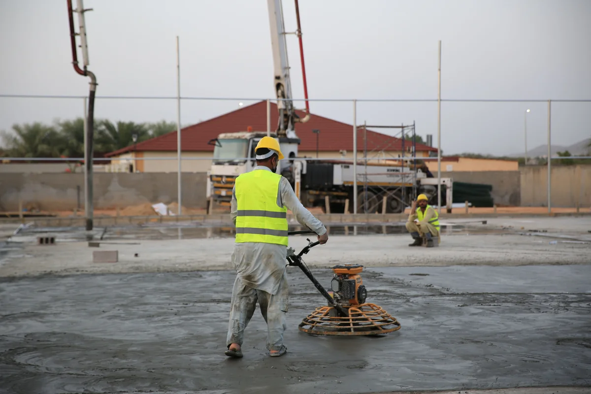 Power trowel finishing a fresh concrete slab