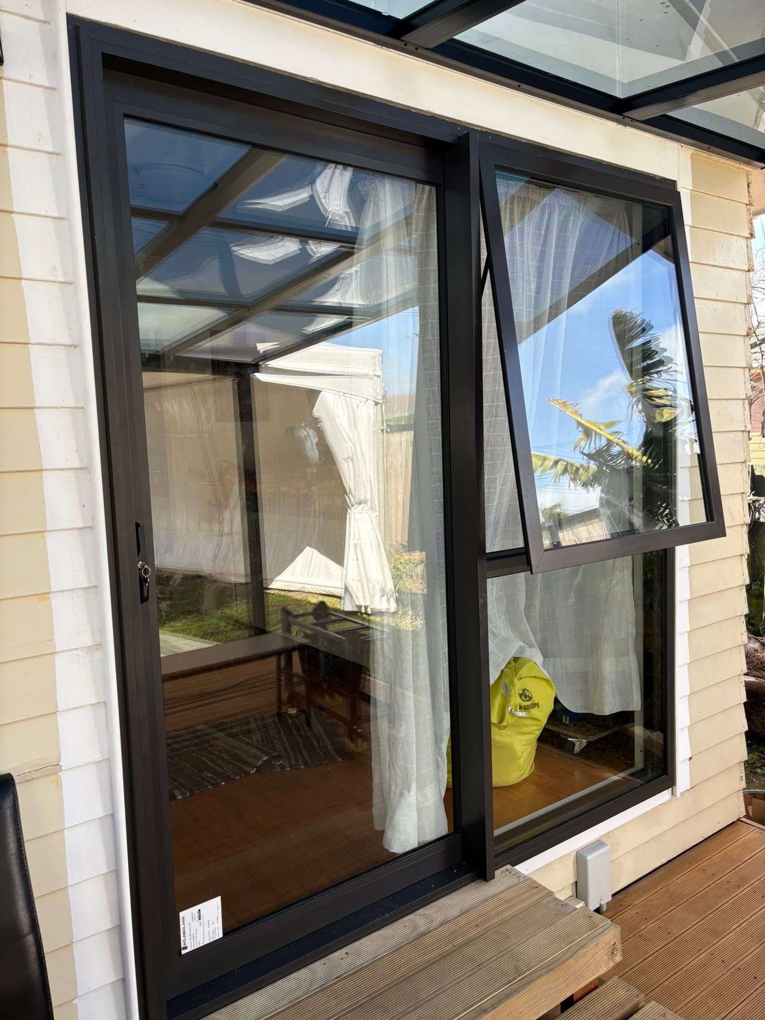 White aluminium six-panel front door with arched glass and matching side lights