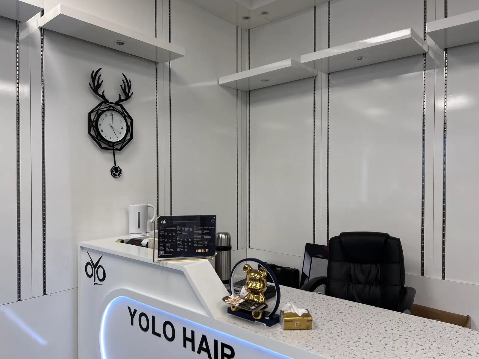 The Yolo Hair reception desk in the bright, white salon.