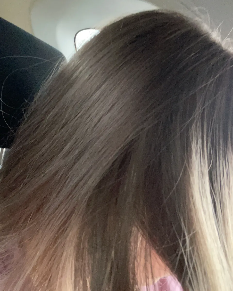 Close view of dark hair with soft, lighter ends.