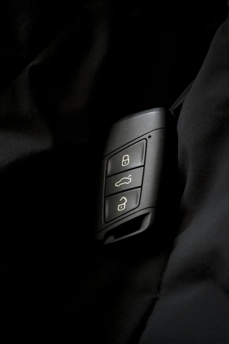 Car key remote showing lock, unlock and boot buttons