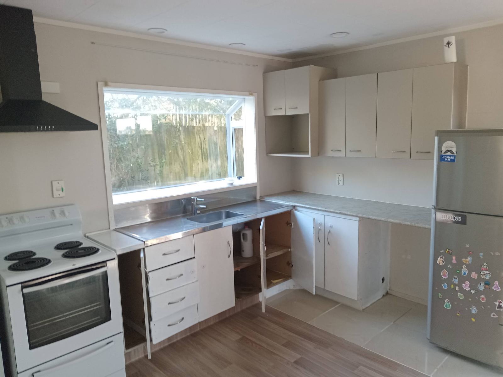 Kitchen cabinets and appliances during renovation work.