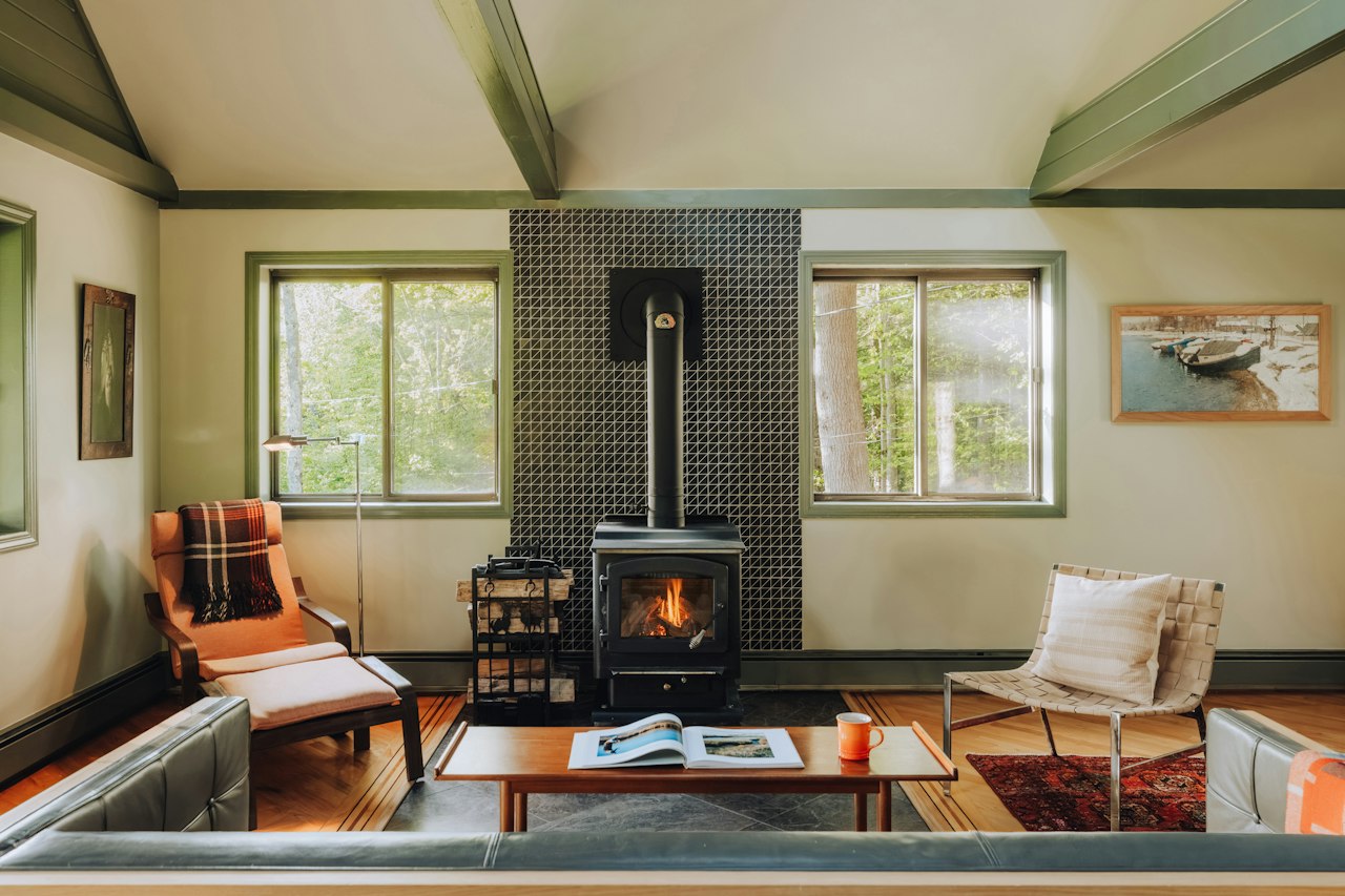 A lit wood burner in a living room.