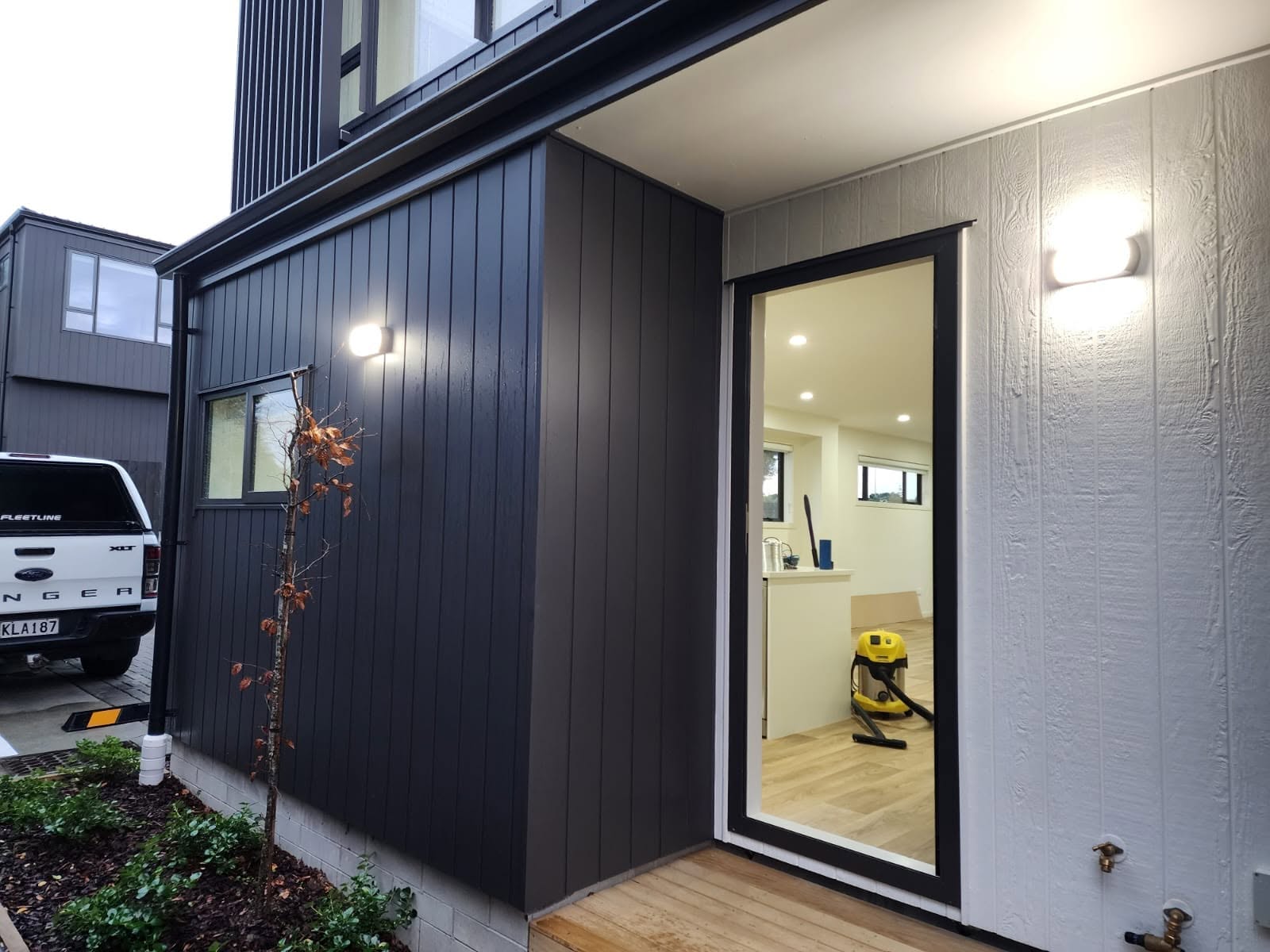Row of homes with warm exterior soffit lighting at night