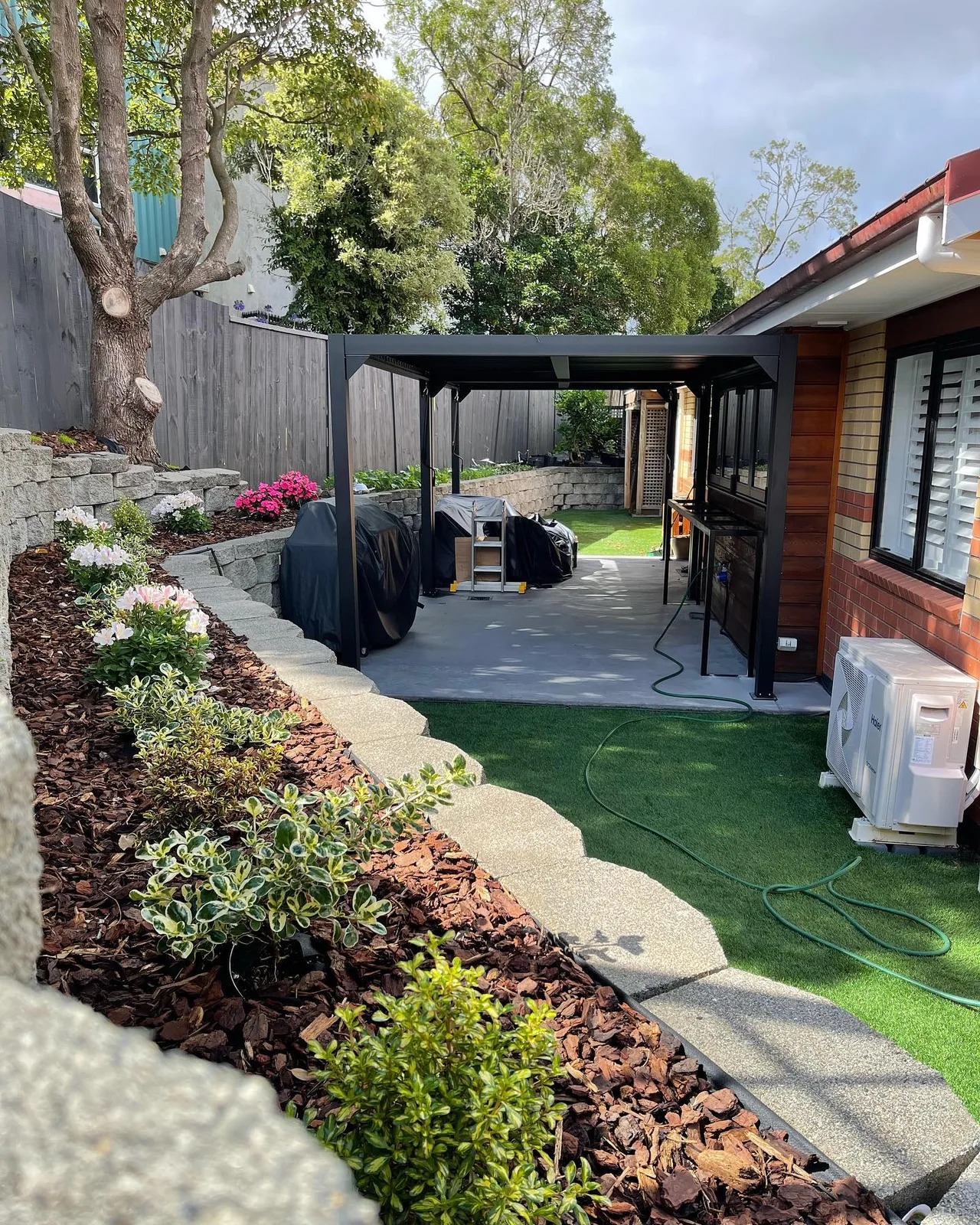 Long timber retaining wall finished with gravel fill