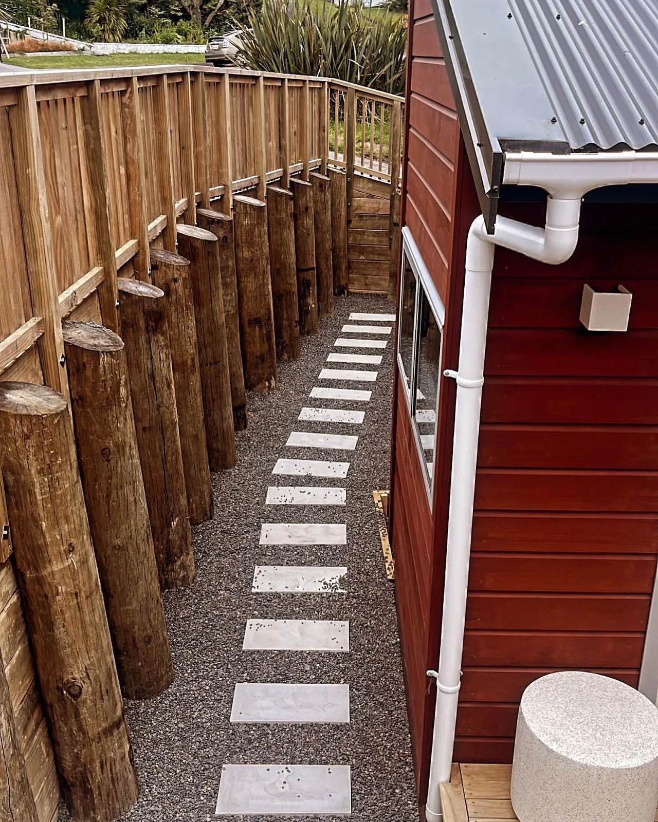 Fresh concrete patio with timber edging beside a house