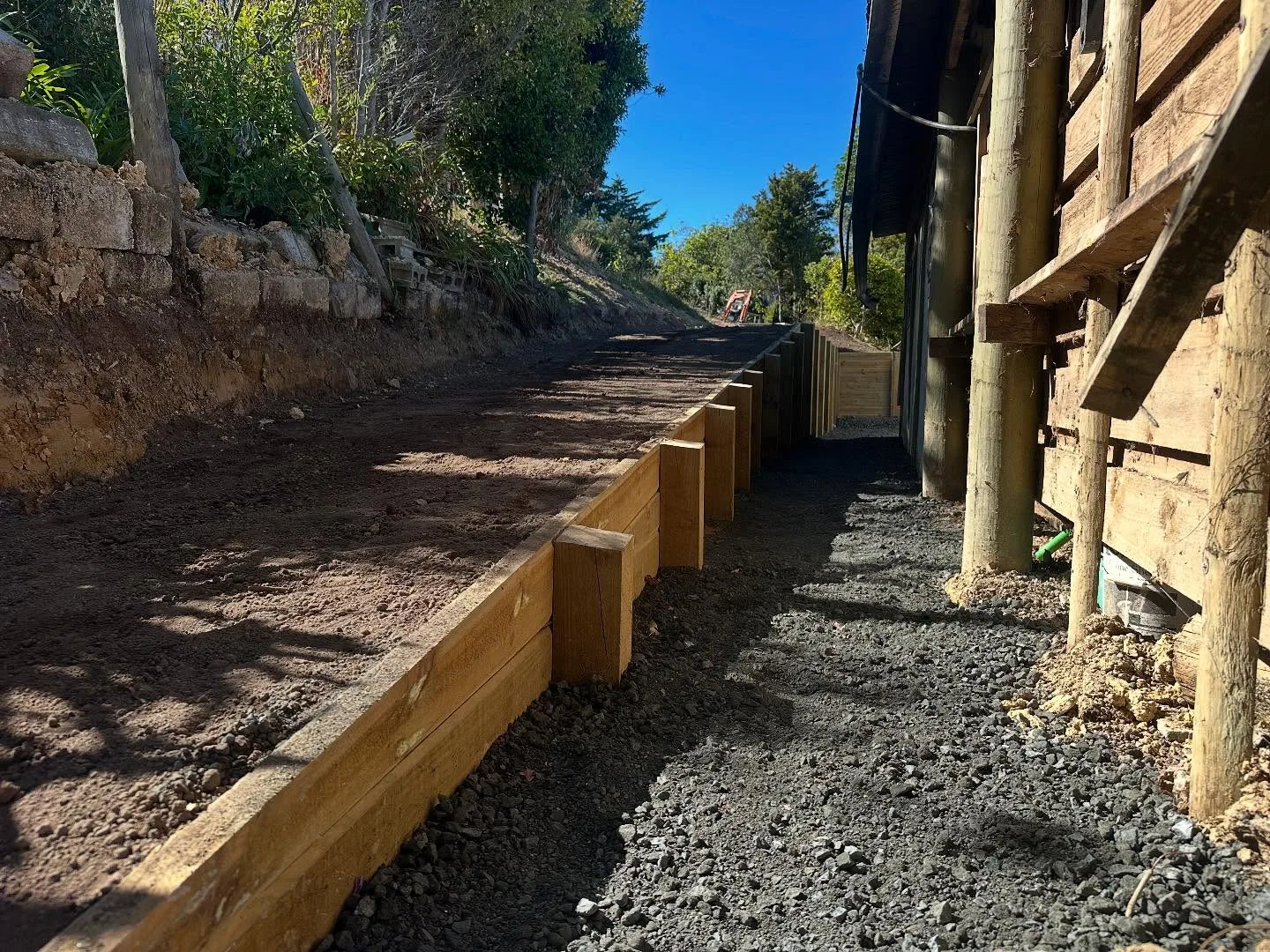 Fresh concrete pour along a timber-edged garage slab