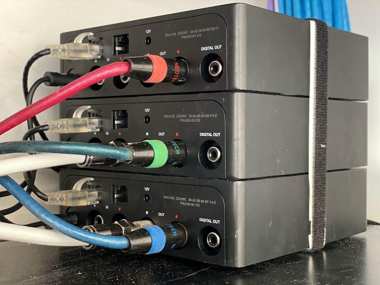 Stacked audio units wired with colour-coded cabling