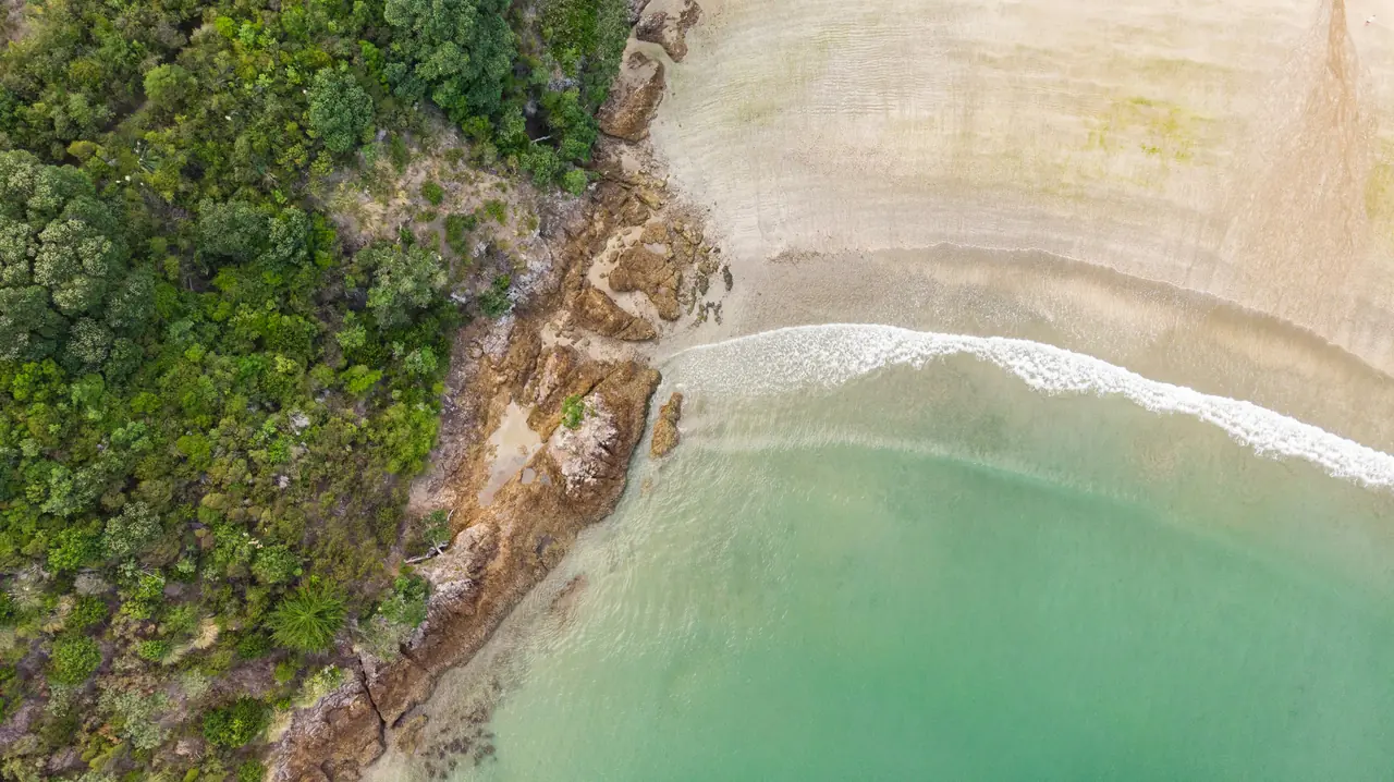 Aerial view of a Waiheke beach and turquoise water